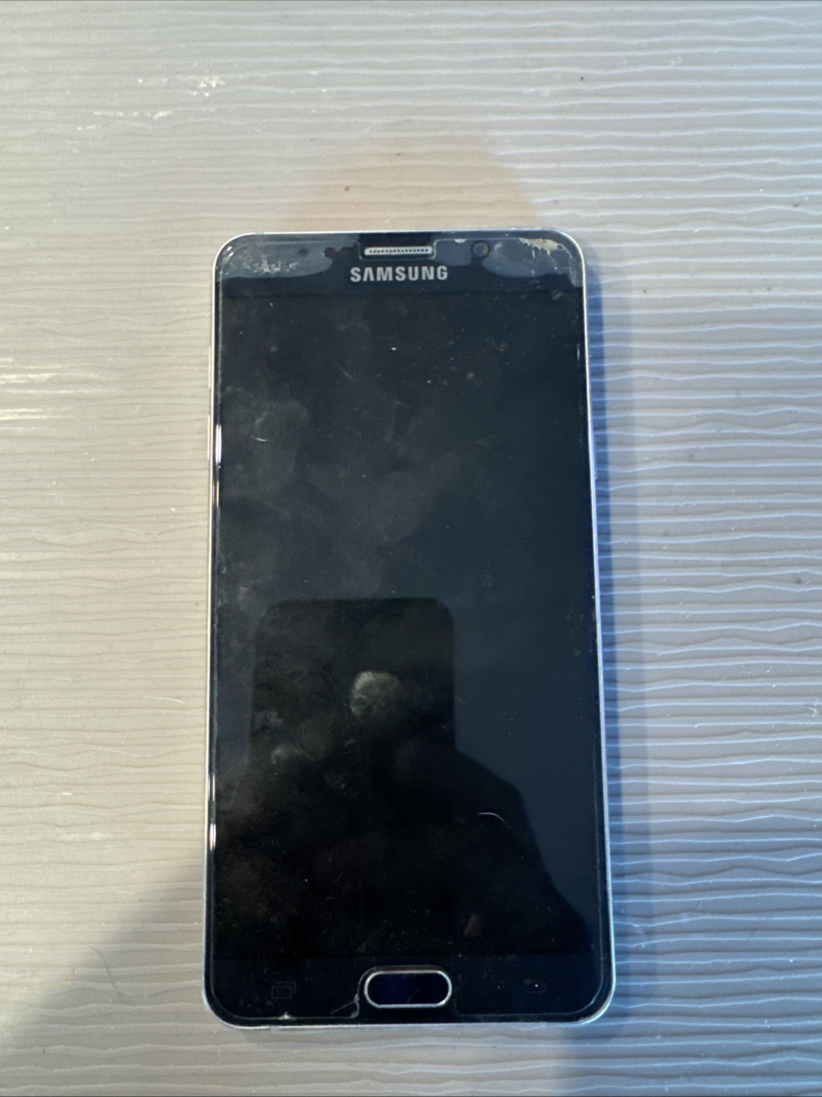 The image shows a Samsung Galaxy Note 5 smartphone.